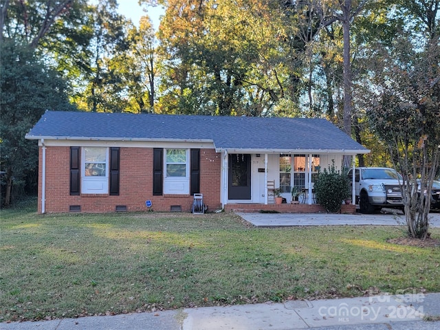 single story home with covered porch and a front lawn