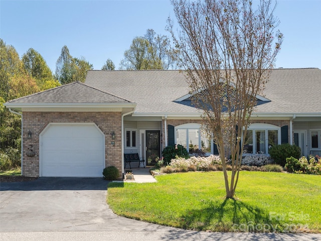 ranch-style home with a garage and a front lawn