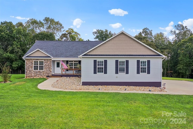 ranch-style home featuring a front yard