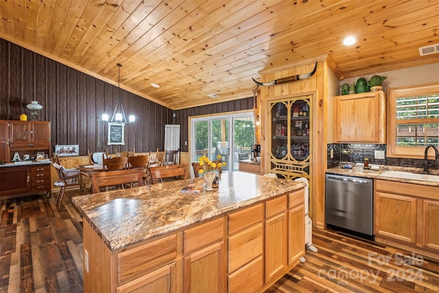 kitchen with sink, dark wood-type flooring, a center island, and stainless steel dishwasher