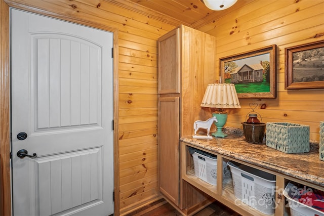 mudroom with wood walls