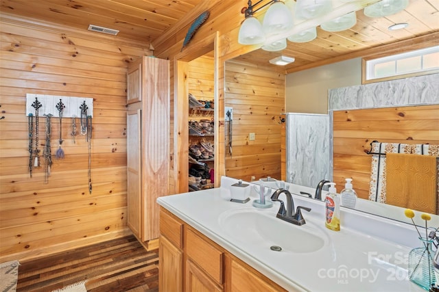 bathroom featuring vanity, hardwood / wood-style flooring, wooden ceiling, and wood walls