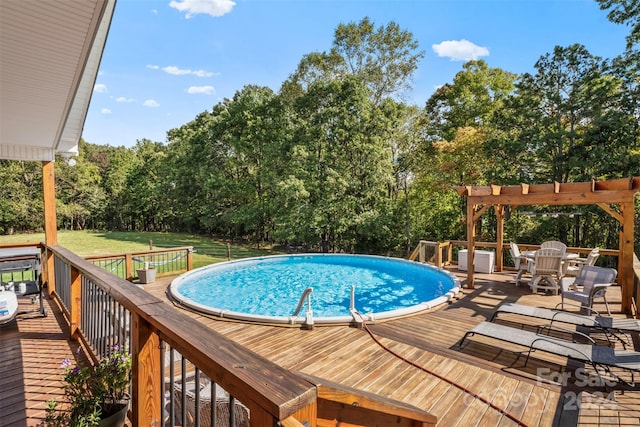 view of pool featuring a pergola, a deck, and a yard