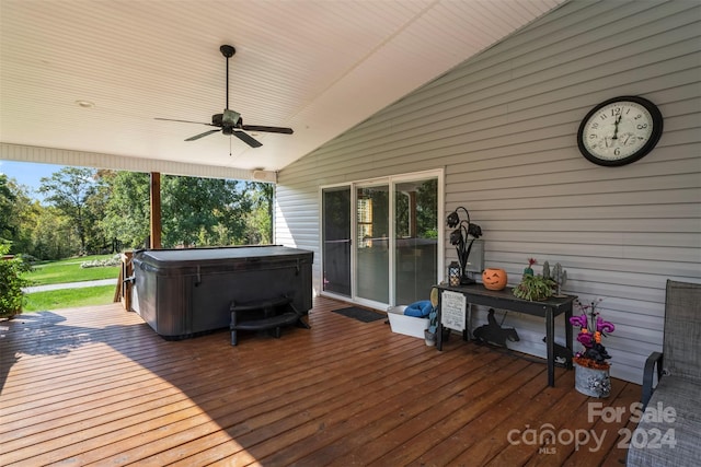 wooden deck with a hot tub and ceiling fan