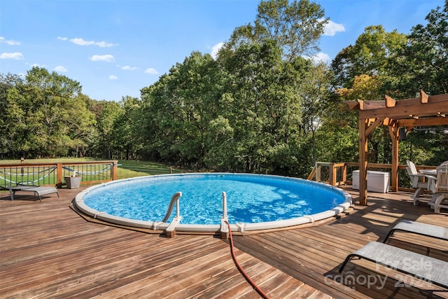 view of swimming pool featuring a yard, a deck, and a pergola