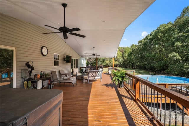 wooden terrace featuring ceiling fan and an outdoor living space