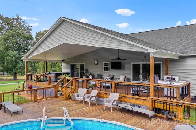 back of property featuring a swimming pool side deck and ceiling fan