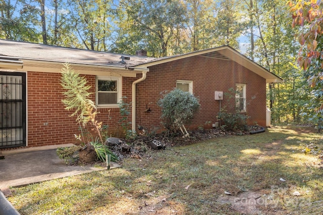 view of side of home featuring a yard