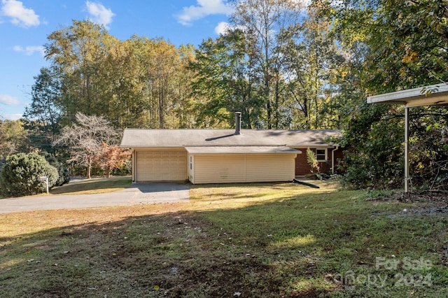 exterior space with a yard and a garage