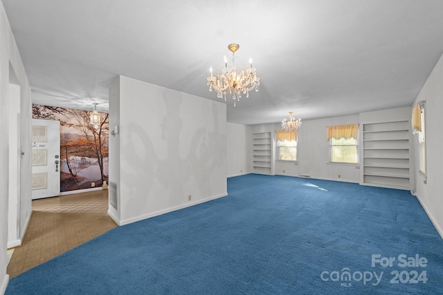 unfurnished living room featuring a notable chandelier and dark colored carpet