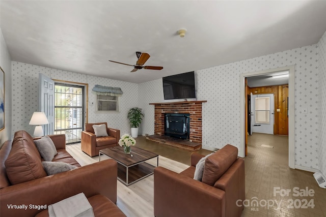 living room with light hardwood / wood-style floors and ceiling fan