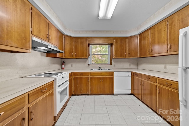 kitchen featuring sink and white appliances