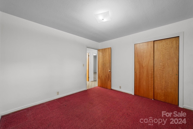 unfurnished bedroom with carpet and a closet