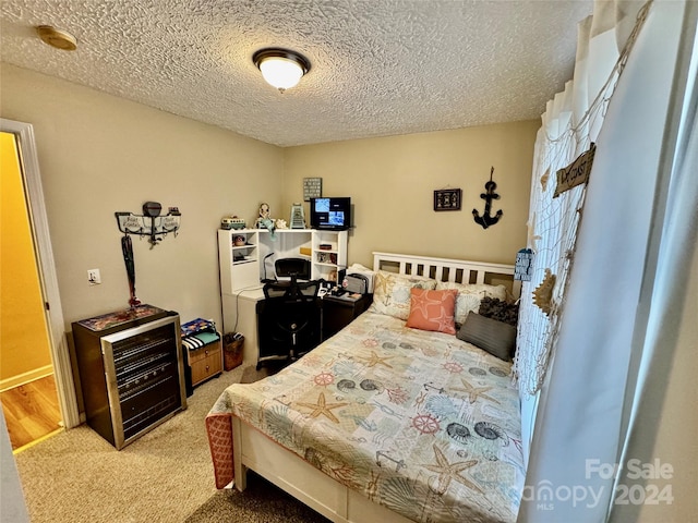 bedroom featuring carpet and a textured ceiling