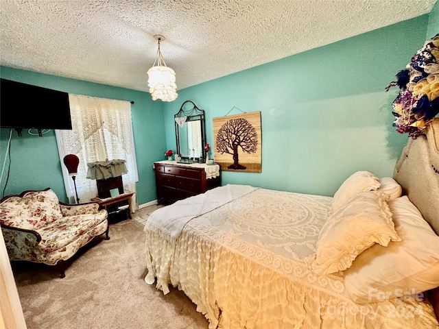 carpeted bedroom featuring a textured ceiling and a chandelier