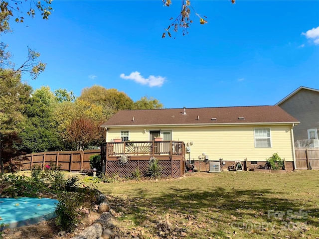 rear view of property with a yard and a deck