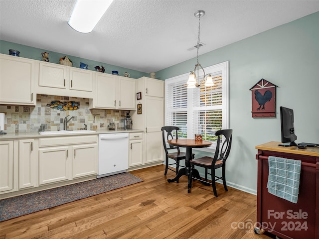 kitchen featuring white cabinetry, white dishwasher, and hanging light fixtures