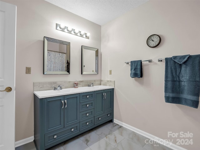 bathroom featuring vanity and a textured ceiling