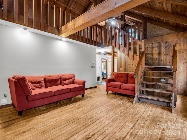 living room featuring beam ceiling, high vaulted ceiling, wooden ceiling, and light hardwood / wood-style floors