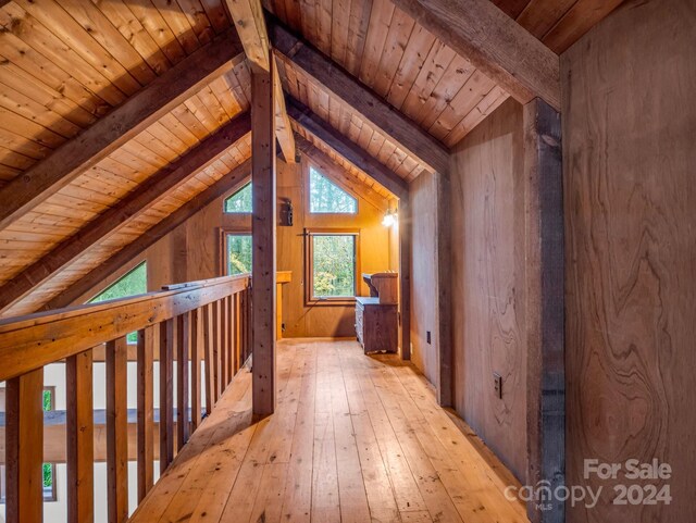 bonus room with light hardwood / wood-style floors, vaulted ceiling with beams, wooden ceiling, and wooden walls