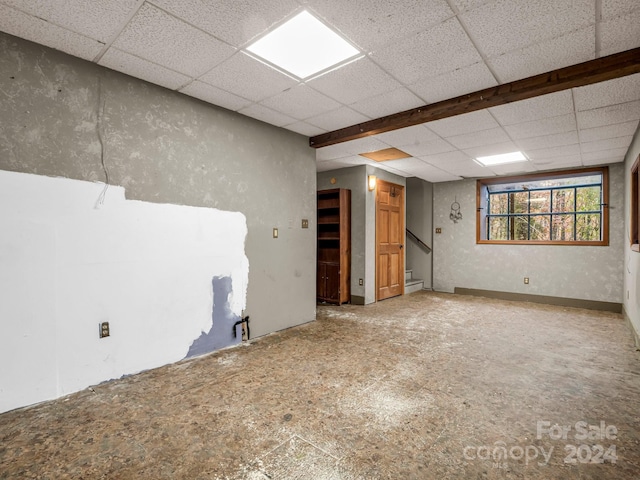 unfurnished room with a drop ceiling