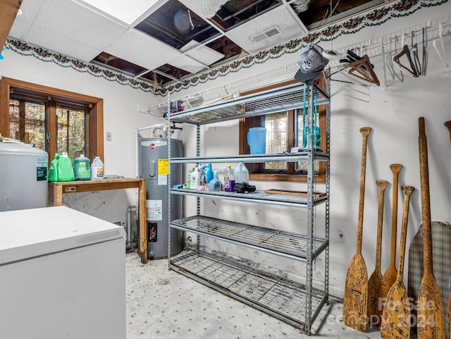 basement with white fridge and water heater