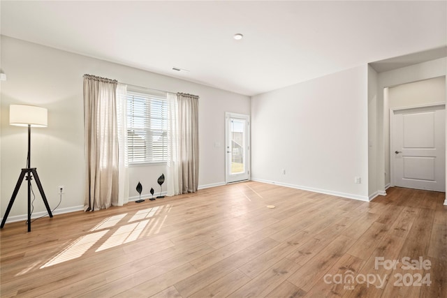 unfurnished room with light wood-type flooring