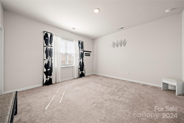 workout room featuring light colored carpet