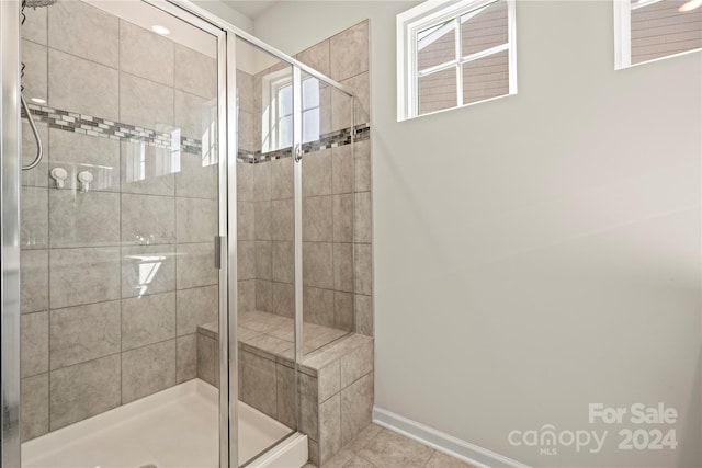 bathroom featuring an enclosed shower and tile patterned flooring