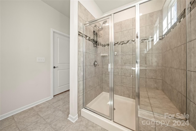 bathroom with walk in shower and tile patterned floors