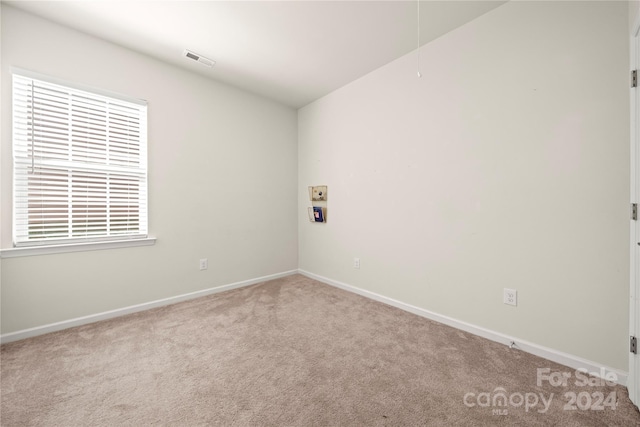 spare room with light colored carpet