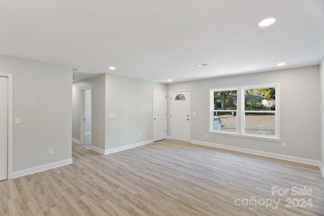 spare room featuring light wood-type flooring