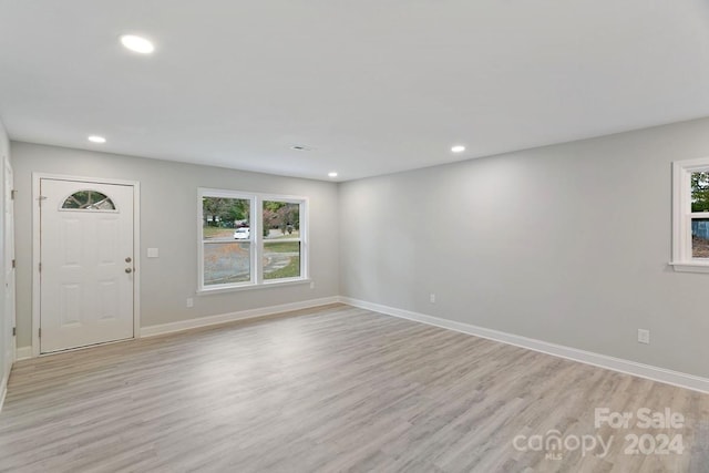 entryway with light hardwood / wood-style flooring and a healthy amount of sunlight