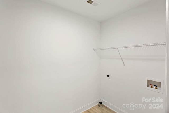 laundry area with electric dryer hookup, washer hookup, and wood-type flooring