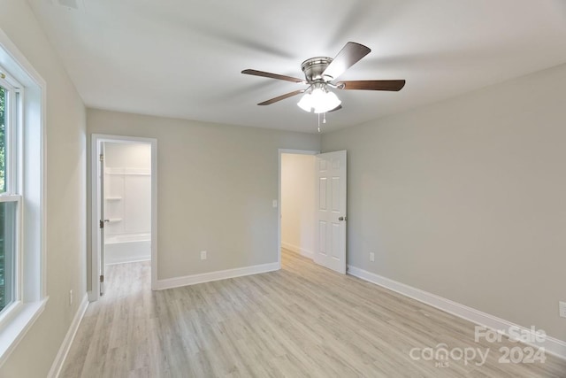 spare room with light wood-type flooring and ceiling fan