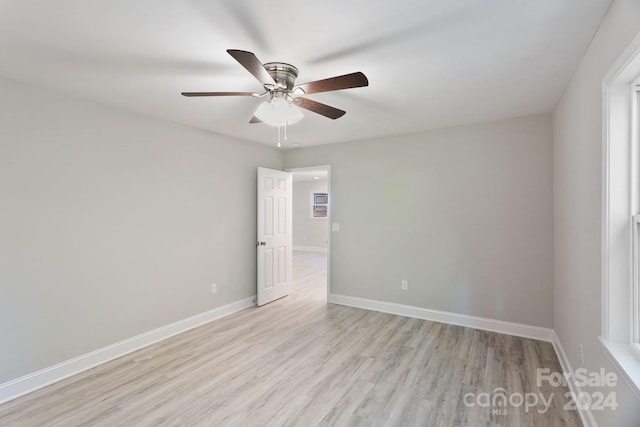 unfurnished room with ceiling fan and light hardwood / wood-style flooring