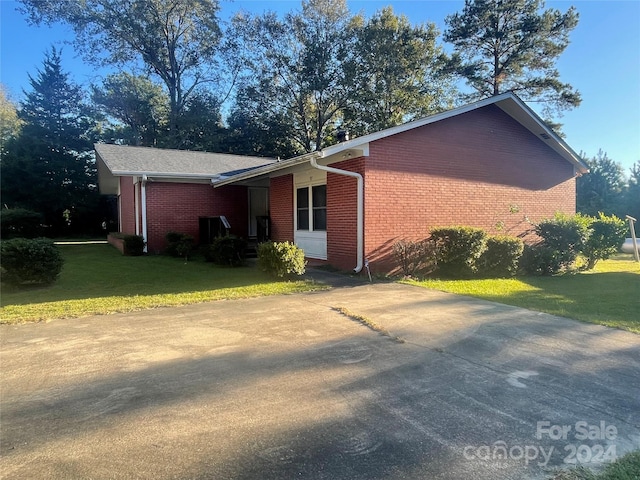 view of side of property with a lawn