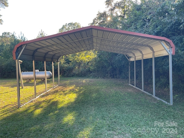 view of parking / parking lot featuring a yard and a carport