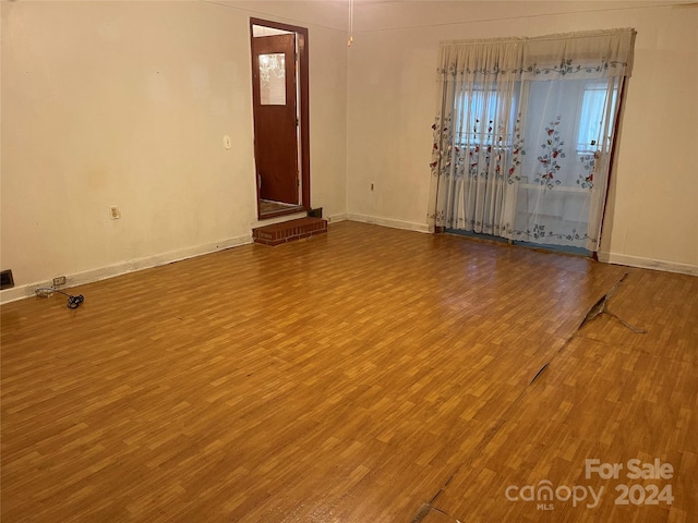 empty room with hardwood / wood-style flooring