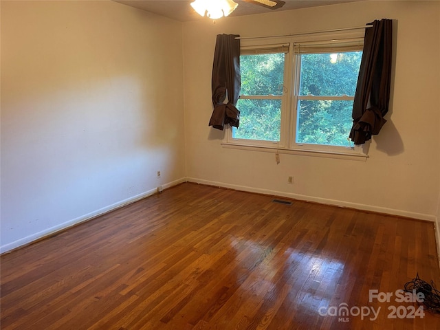 empty room featuring hardwood / wood-style flooring and ceiling fan