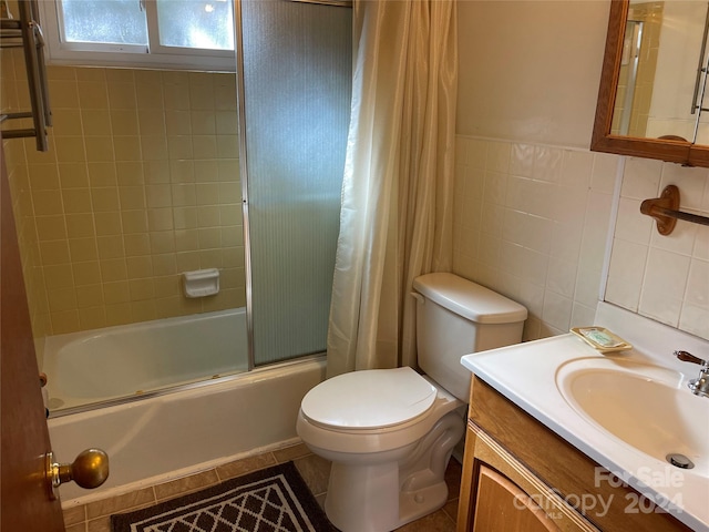 full bathroom featuring shower / tub combo, toilet, tile patterned floors, tile walls, and vanity