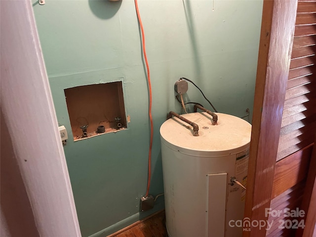 utility room featuring water heater