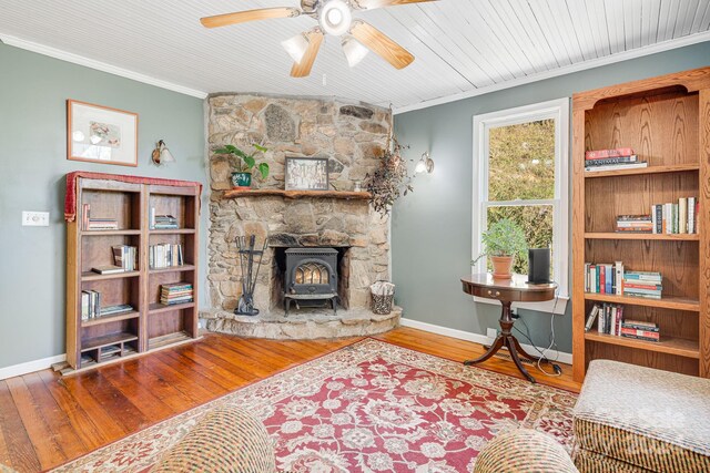 3942 Anderson Branch Rd, Marshall, NC 28753 - living area featuring crown molding, ceiling fan, hardwood / wood-style flooring, a wood stove, and baseboards