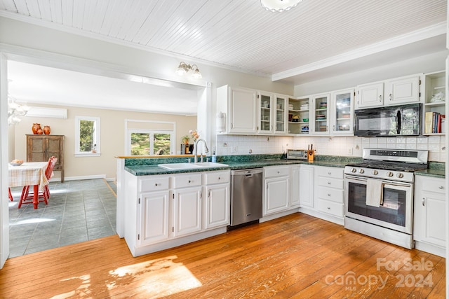 3942 Anderson Branch Rd, Marshall, NC 28753 - kitchen featuring appliances with stainless steel finishes, a sink, dark countertops, white cabinets, and ornamental molding
