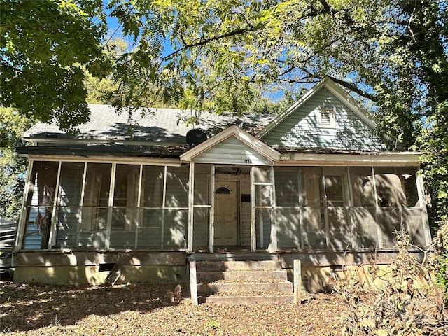 bungalow-style house featuring a sunroom