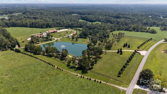 birds eye view of property with a water view and a rural view