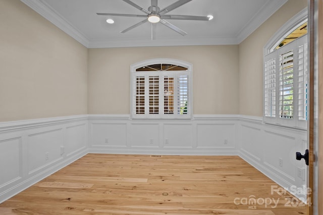 unfurnished room with ceiling fan, light hardwood / wood-style floors, and ornamental molding