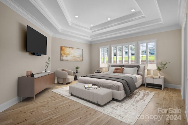 bedroom with light wood-type flooring, crown molding, and a tray ceiling