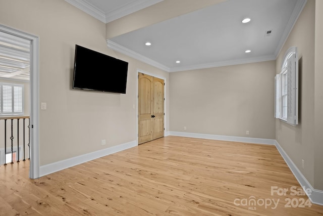 interior space featuring light wood-type flooring and ornamental molding