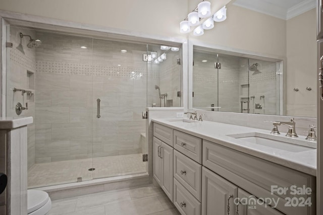 bathroom featuring toilet, tile patterned floors, ornamental molding, vanity, and a shower with shower door